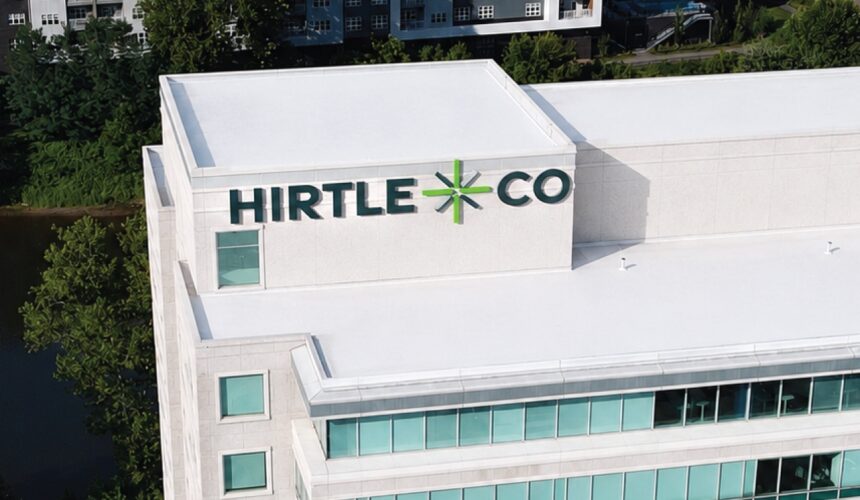 Aerial view of a modern white office building featuring a large 